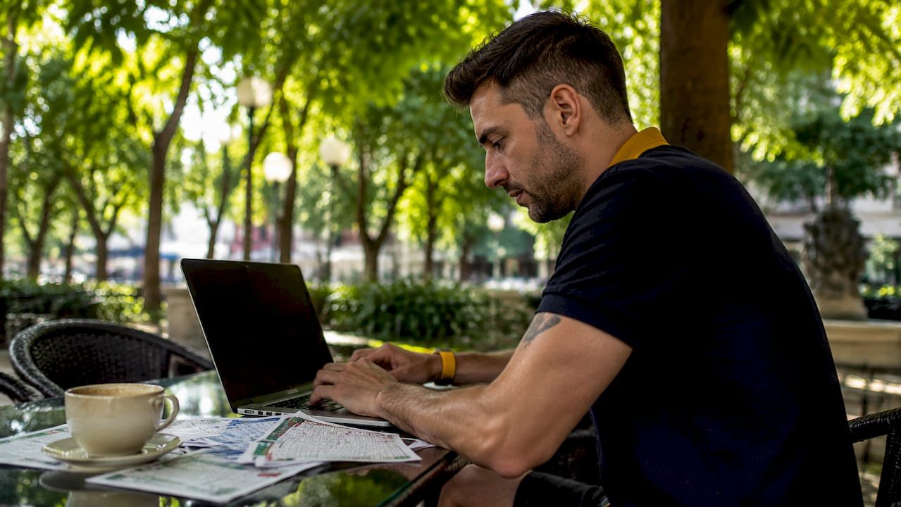 Man tracking betting history at home laptop