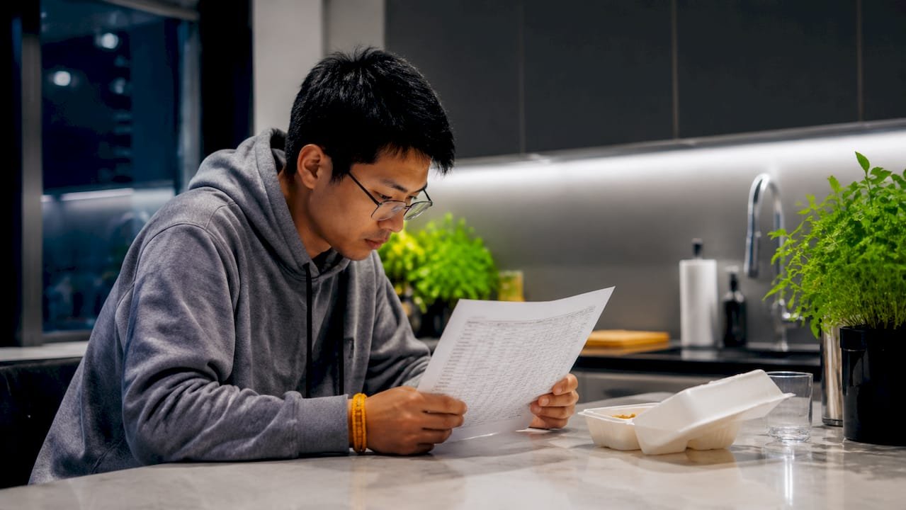 Man checking football betting odds at home