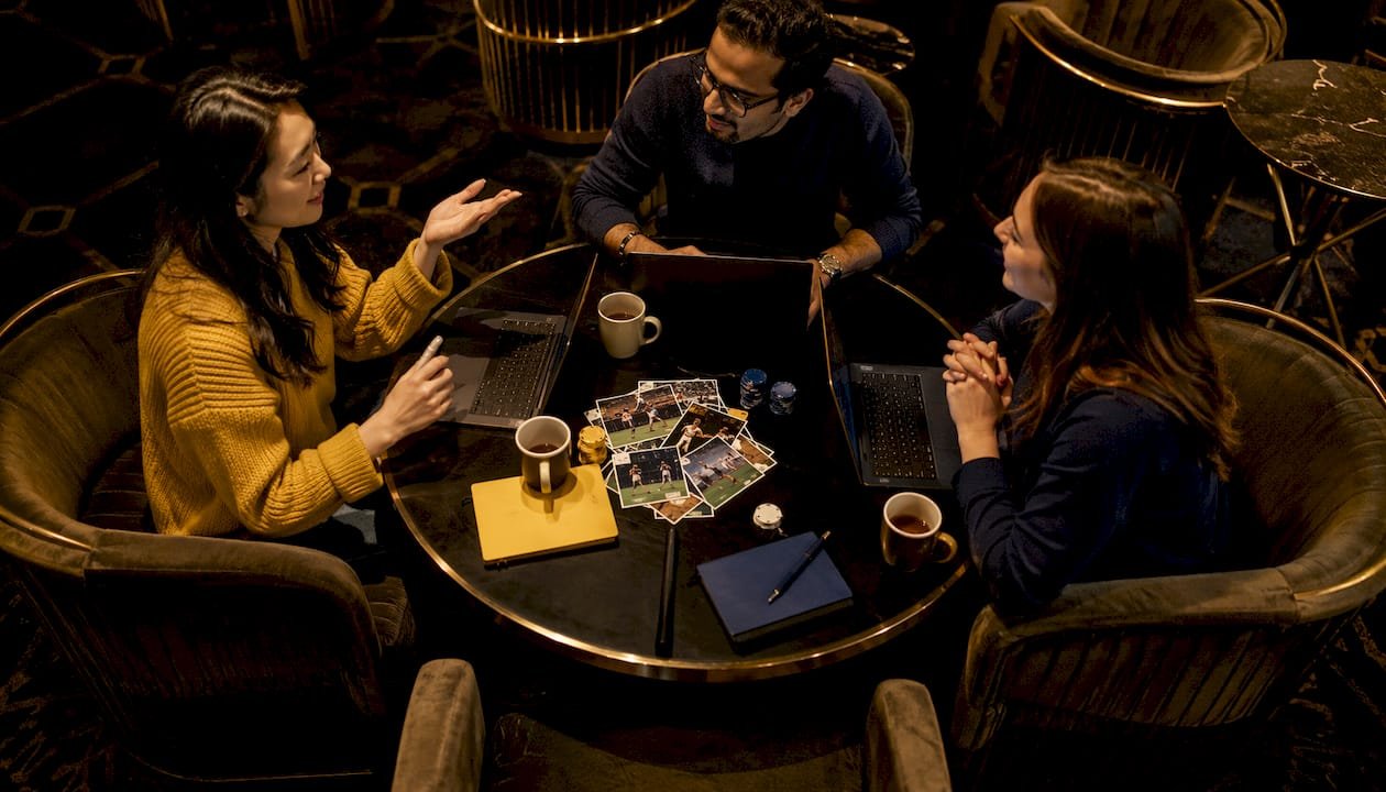 Group collaborating on football betting strategies